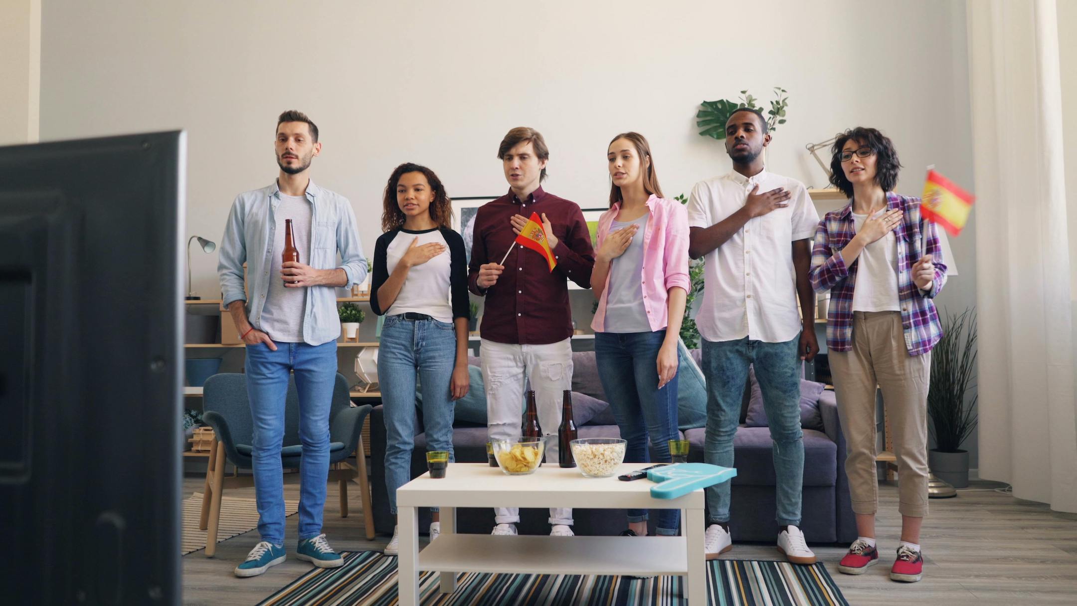 Spaniards sing national anthem watching game 