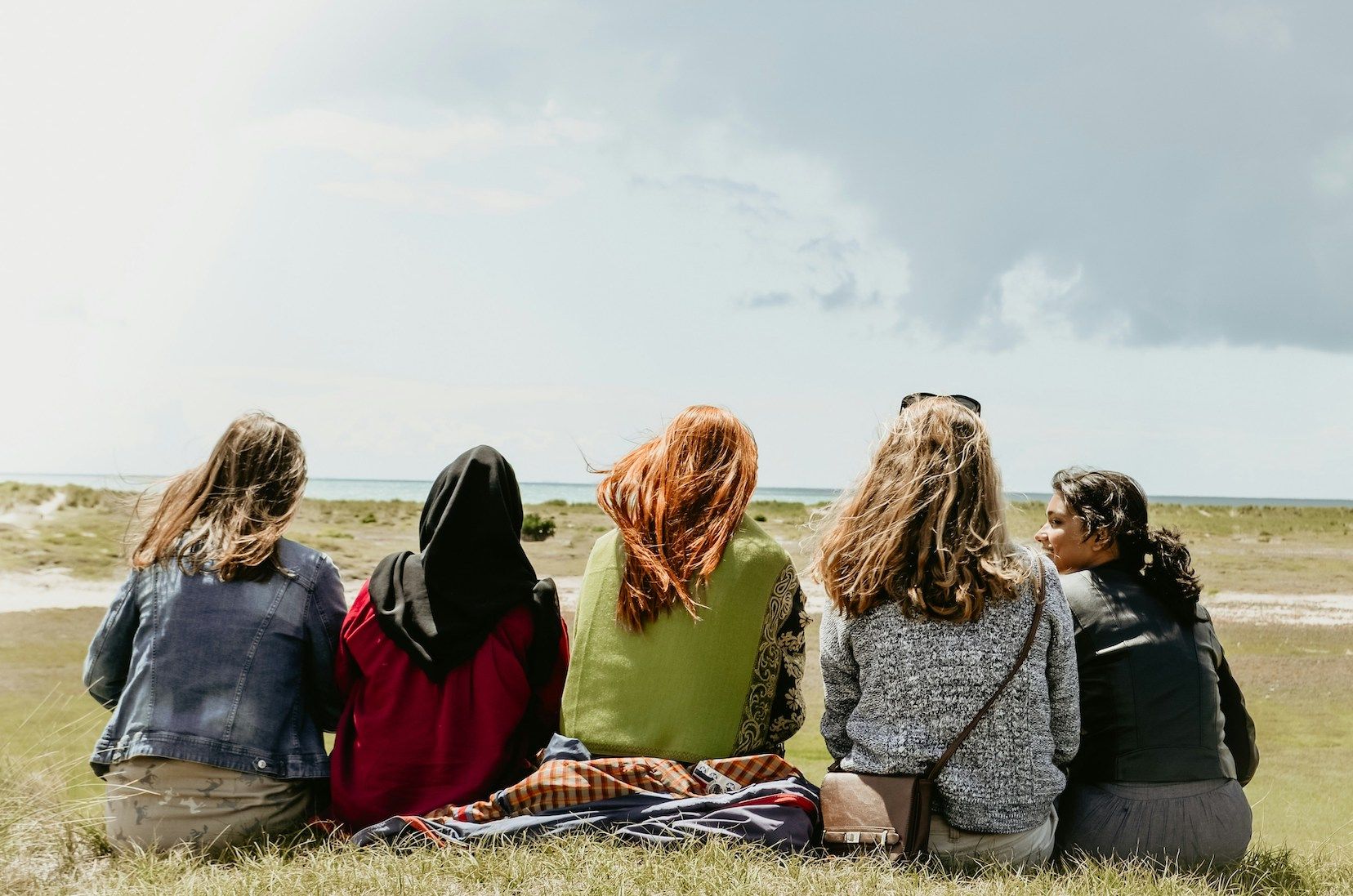group of young diverse women in field