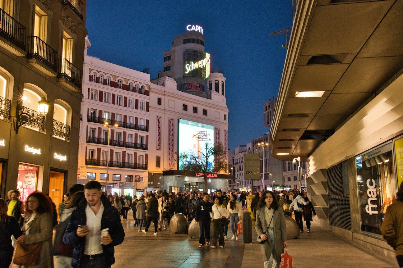 crowded streets of Madrid shipping district at night in cold weather