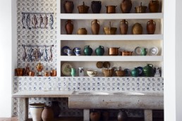 Restaurant pantry design with blue tiles and antique stoneware
