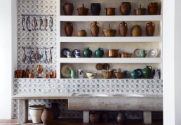 Restaurant pantry design with blue tiles and antique stoneware