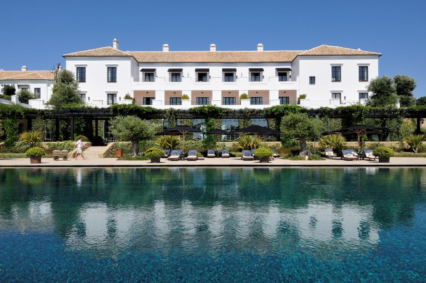 White Mediterranean style hotel looking over pool in Marbella
