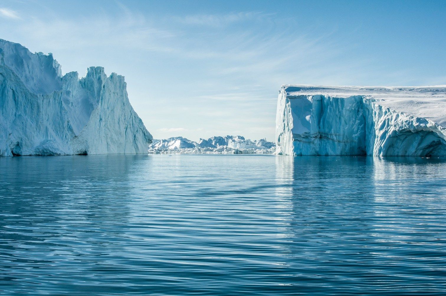 Icebergs floating in blue waters in Greenland