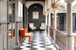 Second floor design elements with charcoal walls and columns at Palacio Villapanés