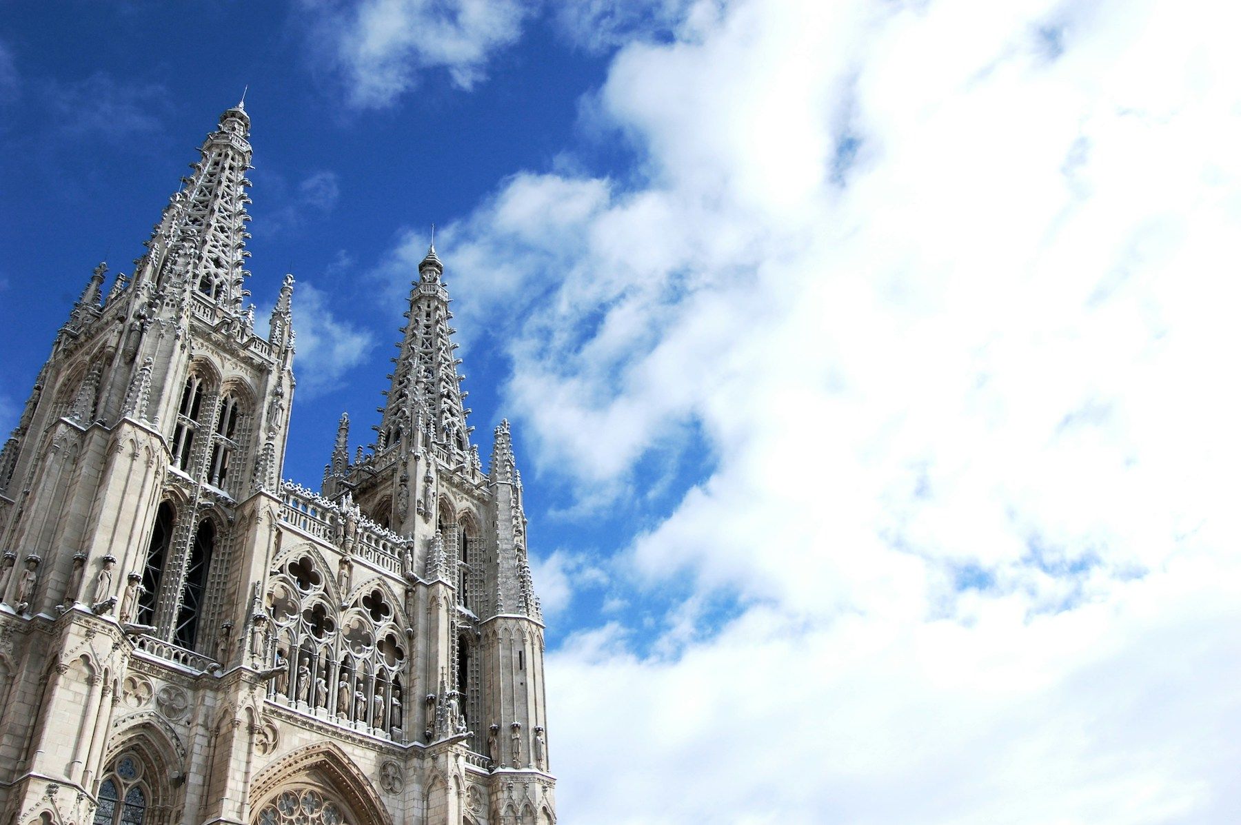 Burgos gothic cathedral against cloudy blue sky